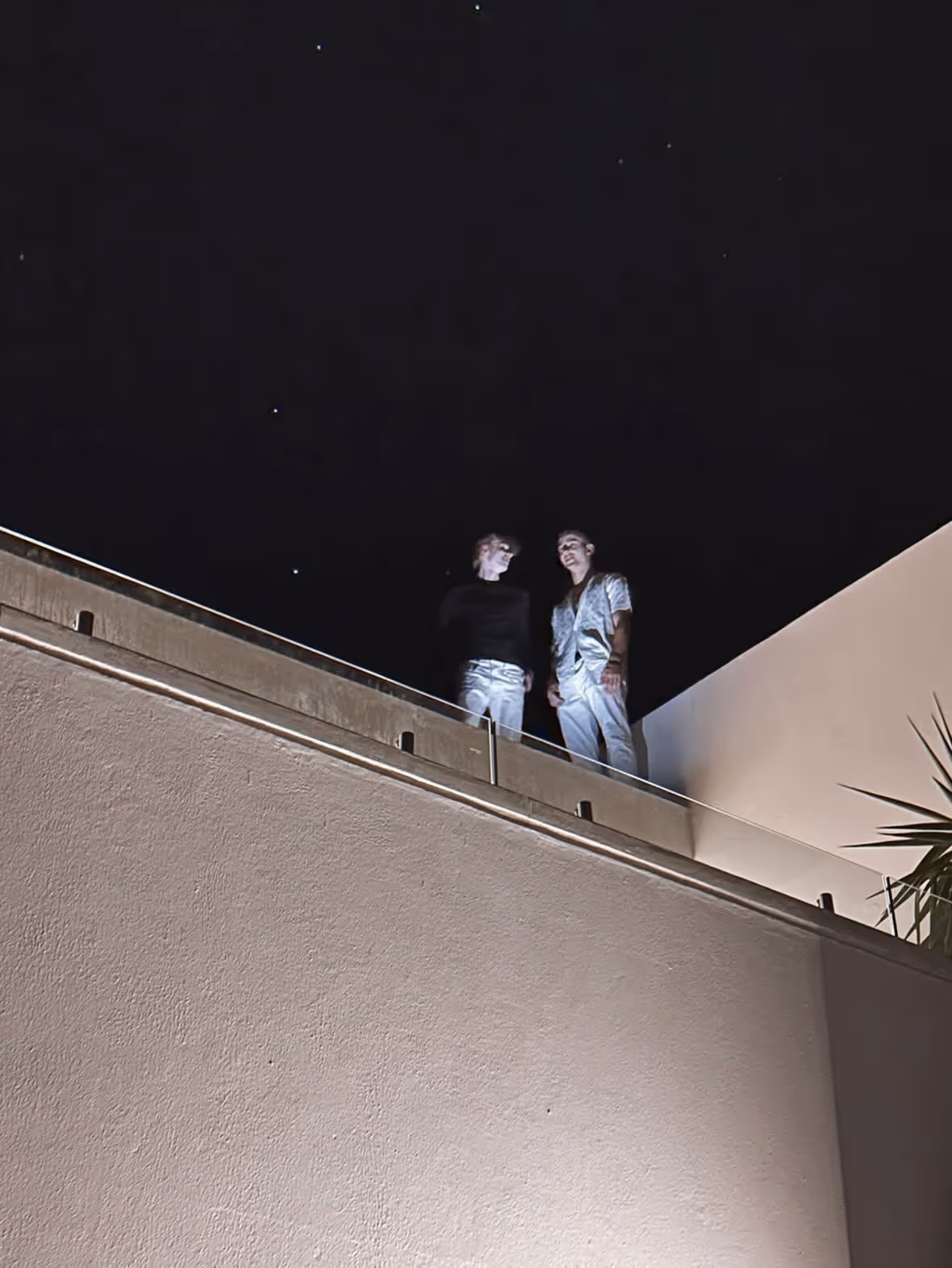 Two Helix founders in a quiet balcony conversation at night in Cape Town Two Helix founders in a quiet balcony conversation at night in Cape Town