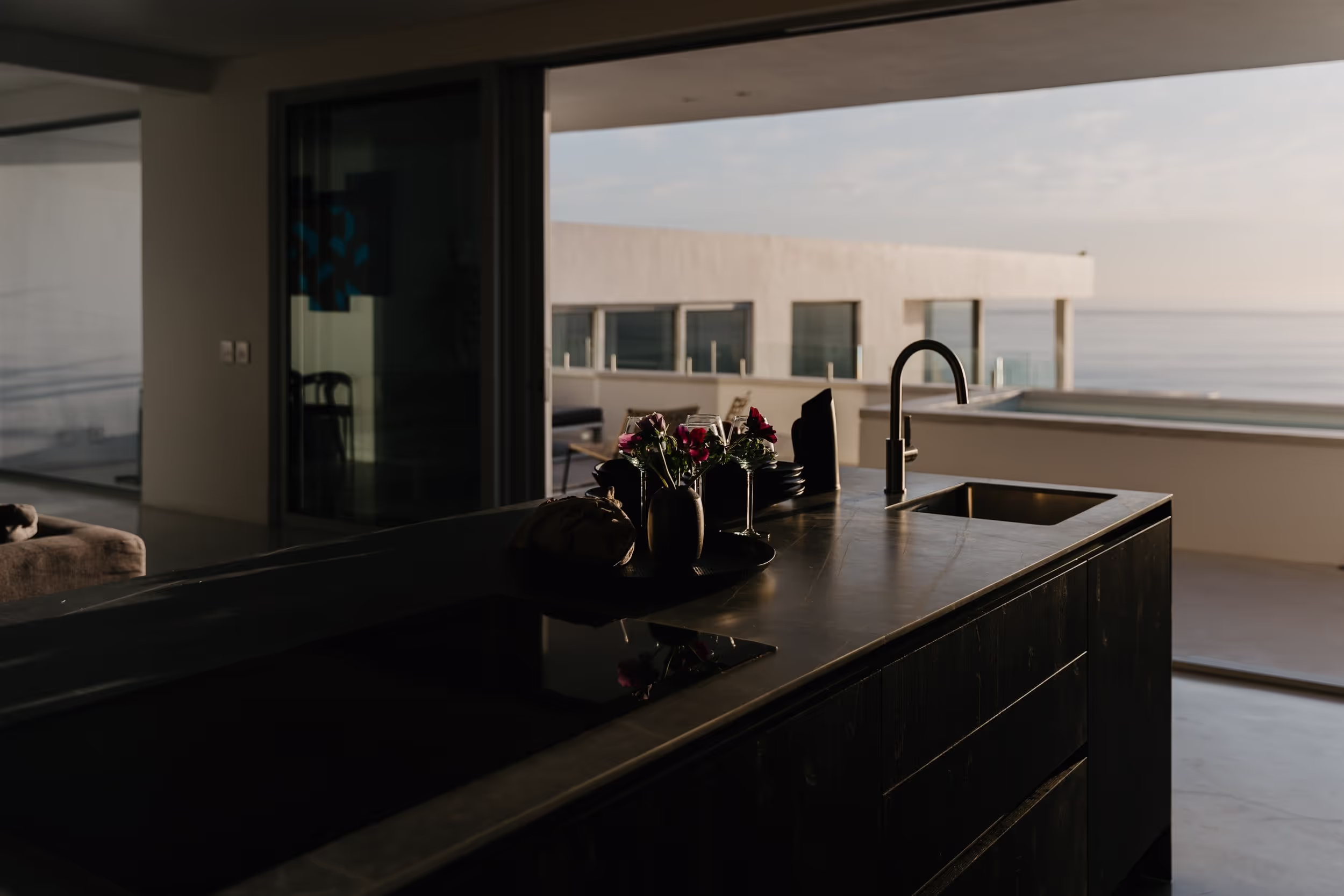 Helix members talking at a Cape Town villa kitchen at dusk Helix members talking at a Cape Town villa kitchen at dusk