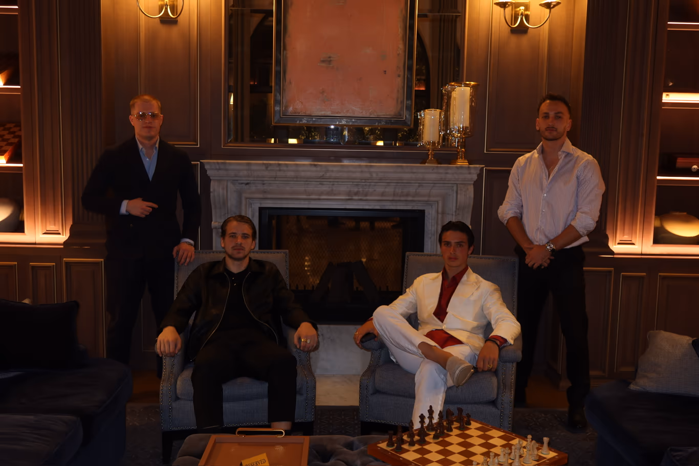 CEO peer group — same altitude, off the record Four founders gathered around a fireplace lounge, a chess game mid-play on the table — a peer group that meets off the record