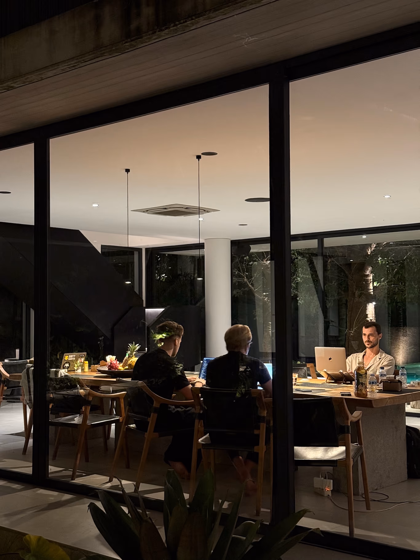 Founder community — measured by the table, not the headcount Founders along a long table in a modern room at night — a community that actually gathers