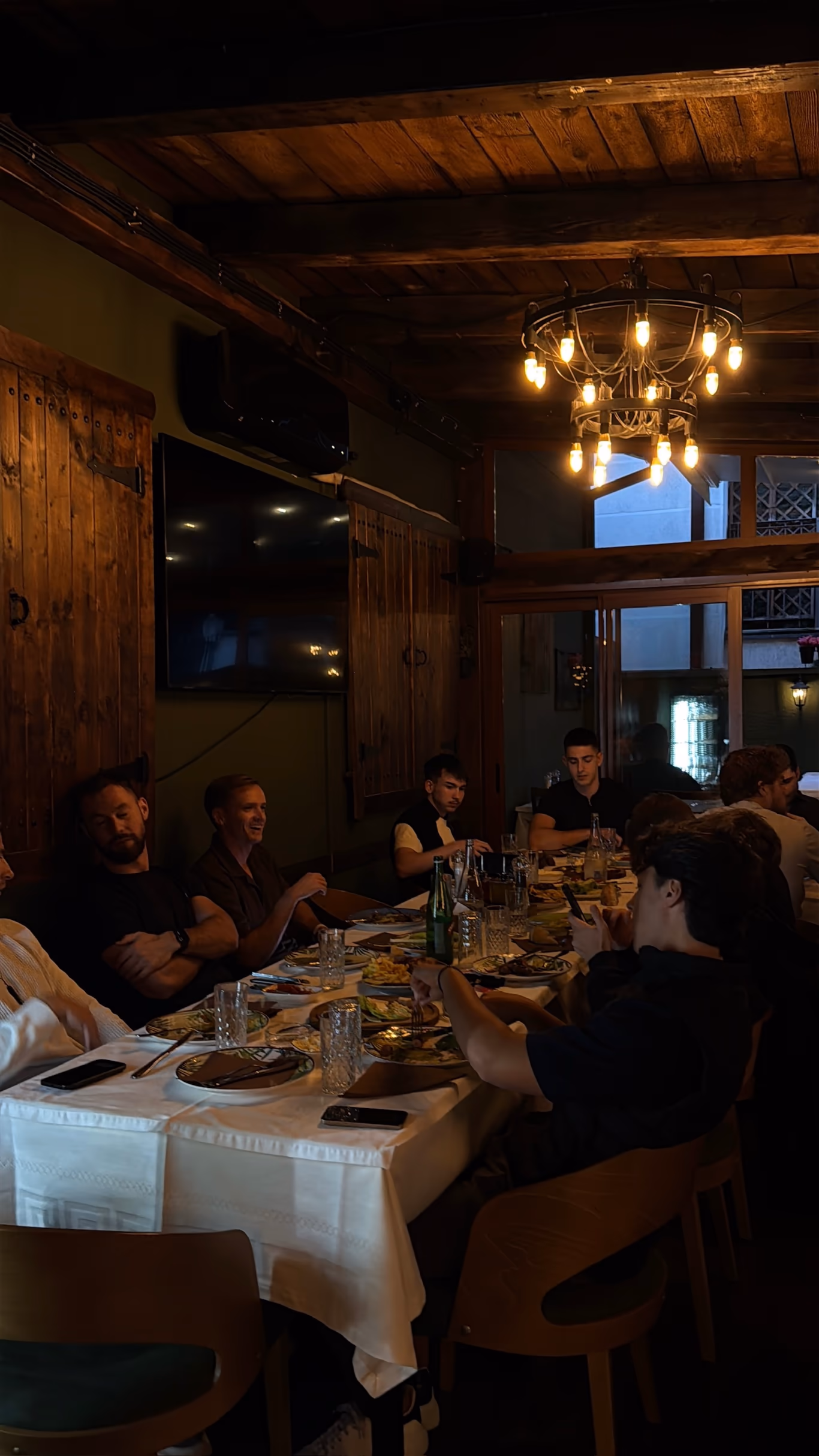 Founders relaxed around a long table in a warm wood-lined room at a Helix gathering